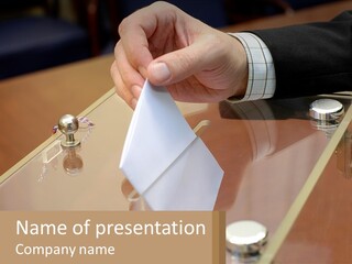 A Person Holding A Piece Of Paper On Top Of A Table PowerPoint Template