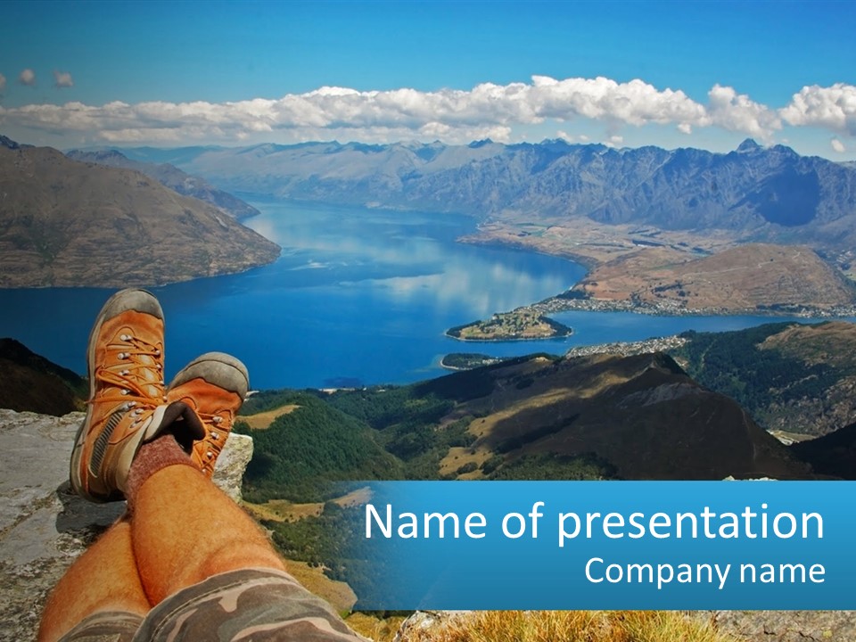 A Person Sitting On Top Of A Mountain Overlooking A Lake PowerPoint Template