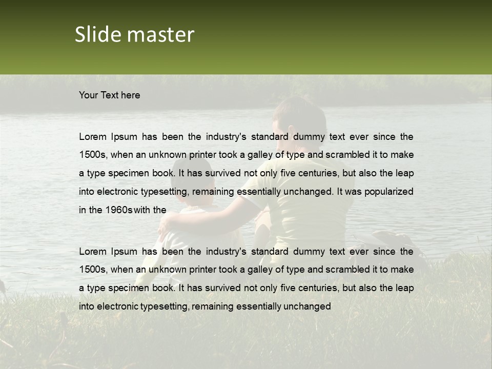 A Man And A Child Sitting On The Grass Near A Body Of Water PowerPoint Template