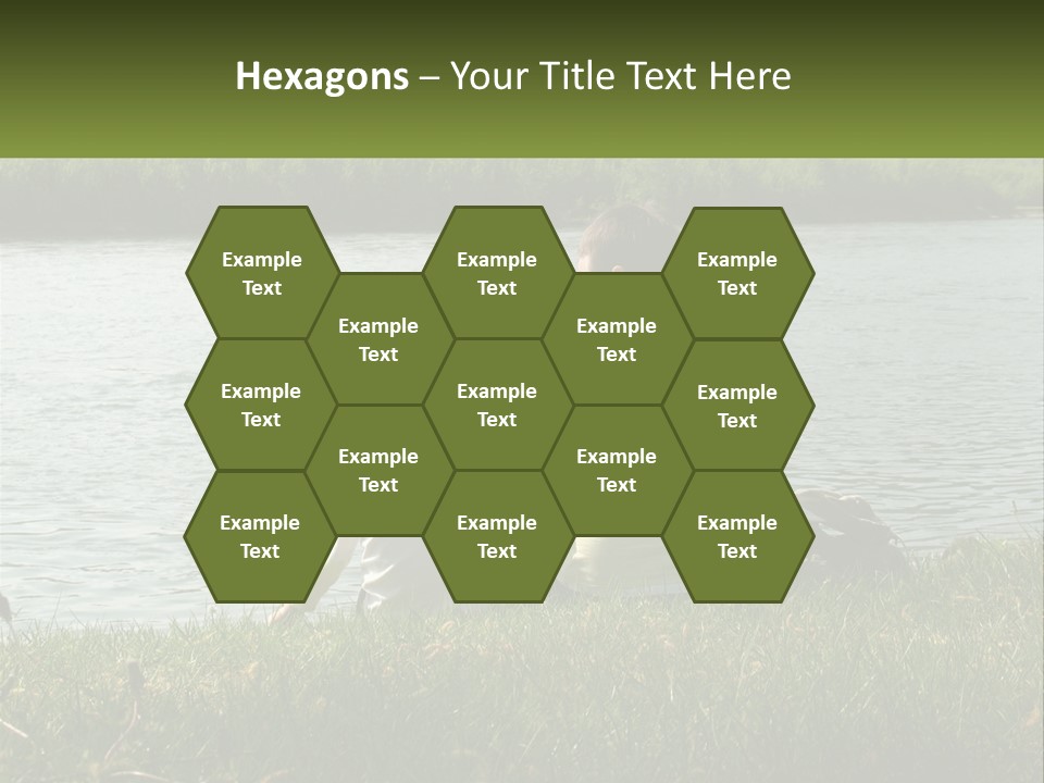 A Man And A Child Sitting On The Grass Near A Body Of Water PowerPoint Template