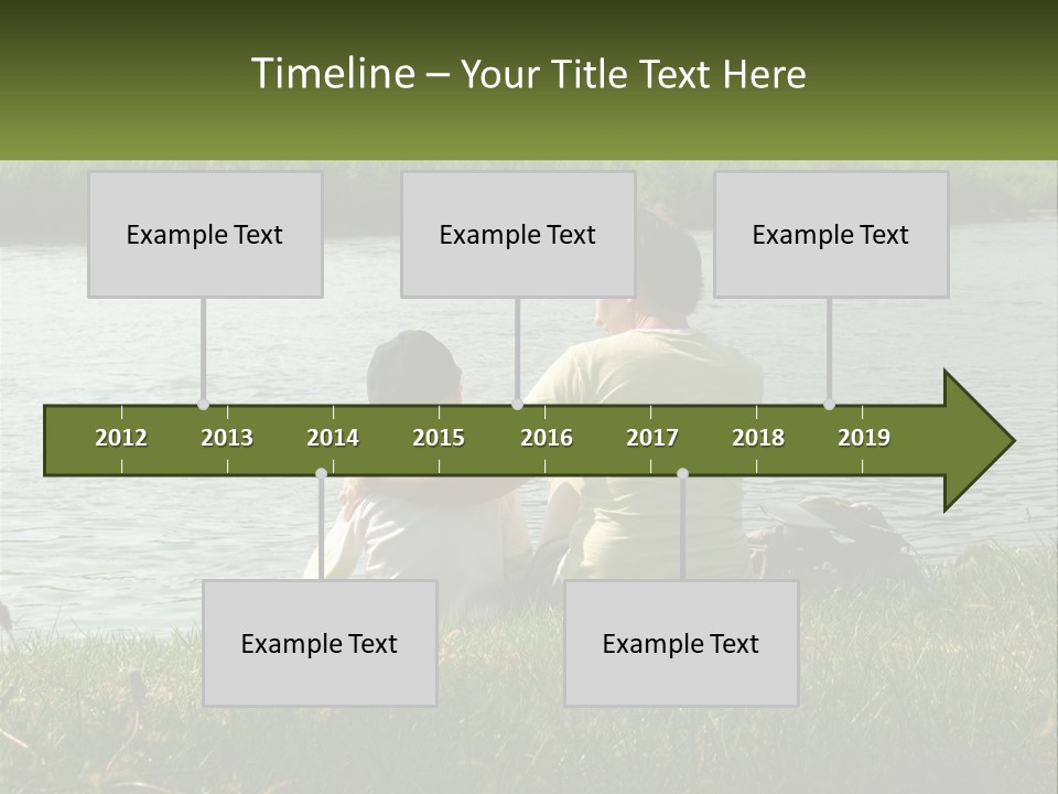 A Man And A Child Sitting On The Grass Near A Body Of Water PowerPoint Template