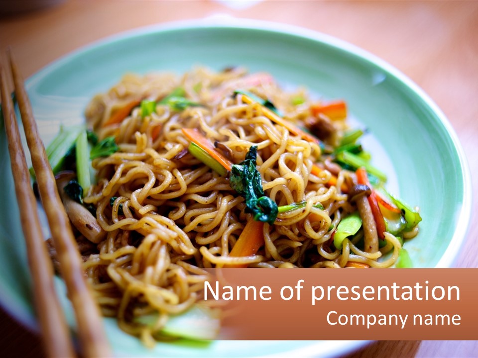 A Plate Of Noodles With Chopsticks On A Table PowerPoint Template