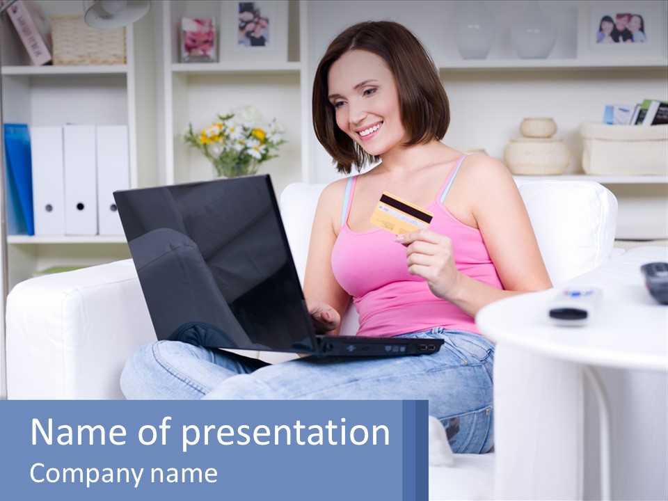 A Woman Sitting On A Couch Holding A Credit Card And A Laptop PowerPoint Template