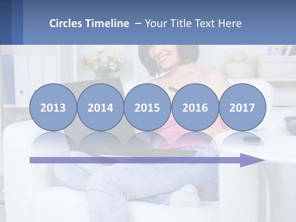 A Woman Sitting On A Couch Holding A Credit Card And A Laptop PowerPoint Template