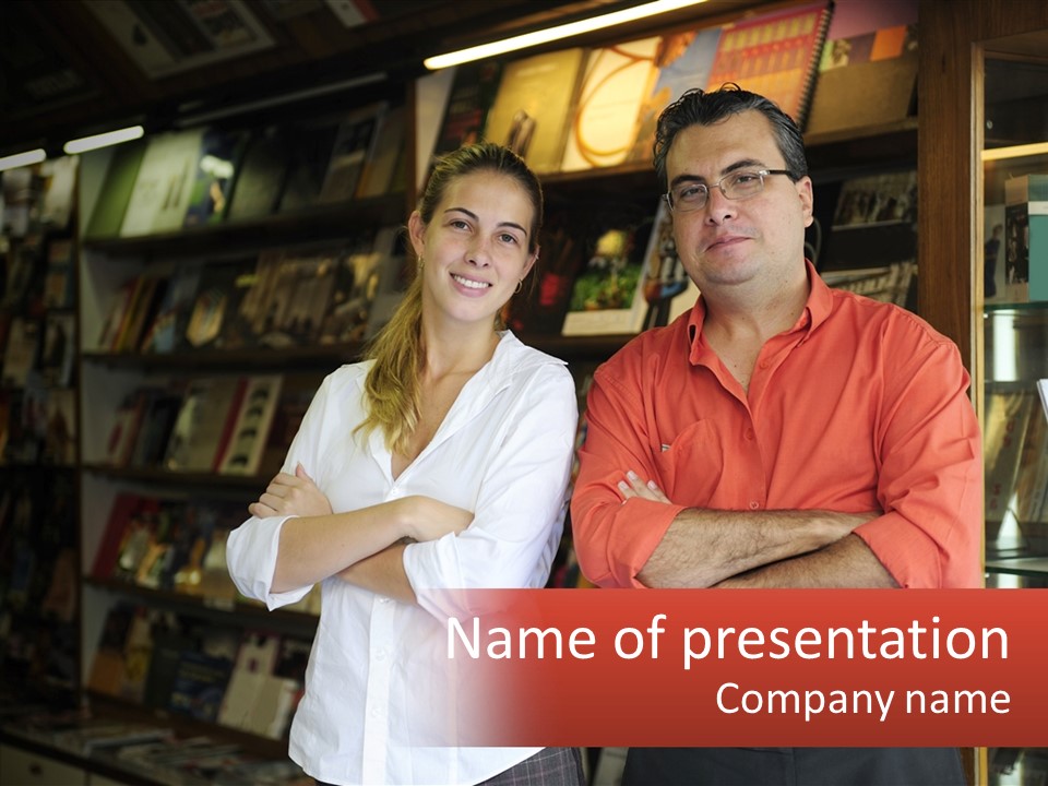 A Man And A Woman Standing In Front Of A Book Shelf PowerPoint Template