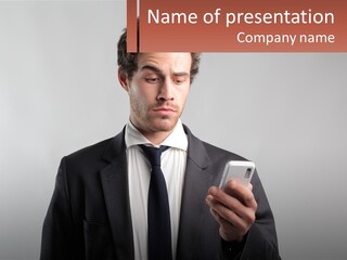 A Man In A Suit Looking At His Cell Phone PowerPoint Template