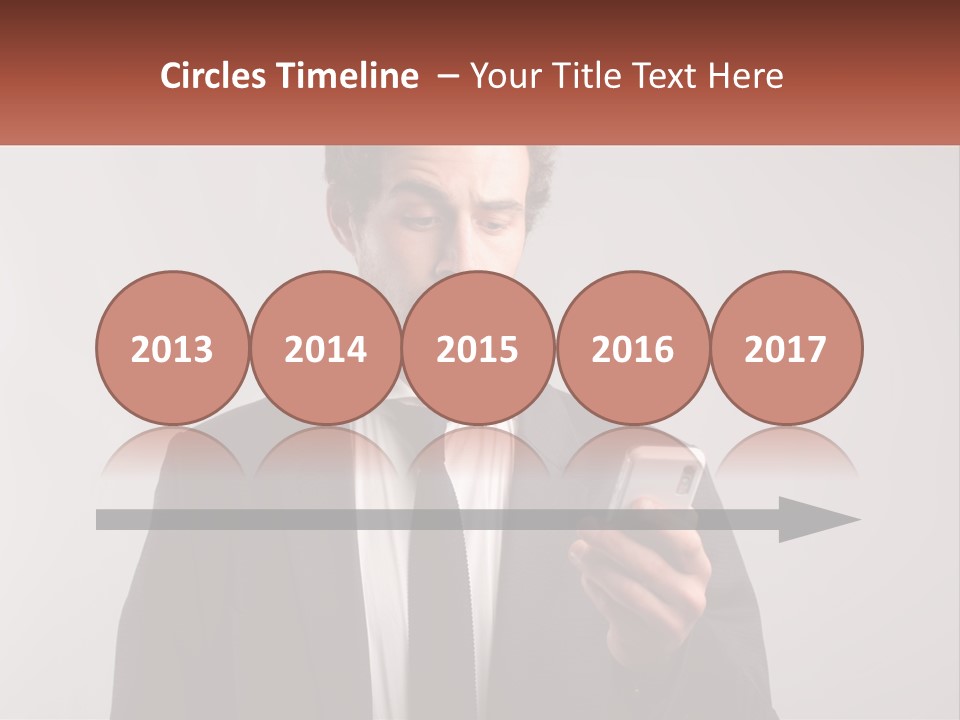 A Man In A Suit Looking At His Cell Phone PowerPoint Template