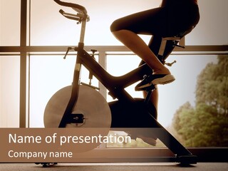 A Woman Riding A Stationary Bike In A Gym PowerPoint Template