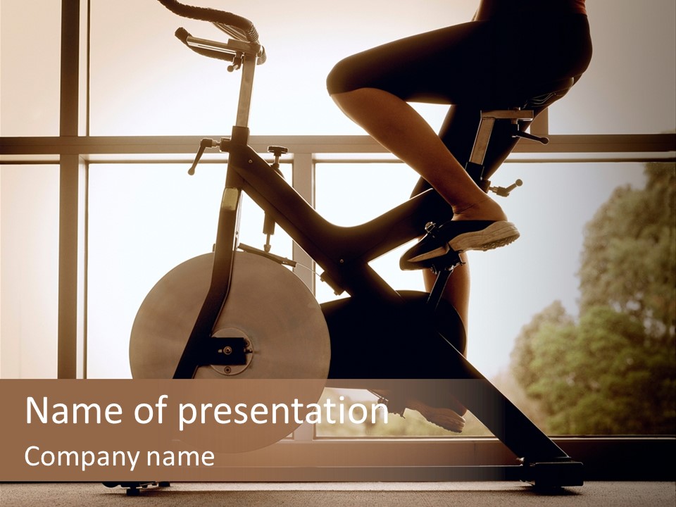 A Woman Riding A Stationary Bike In A Gym PowerPoint Template