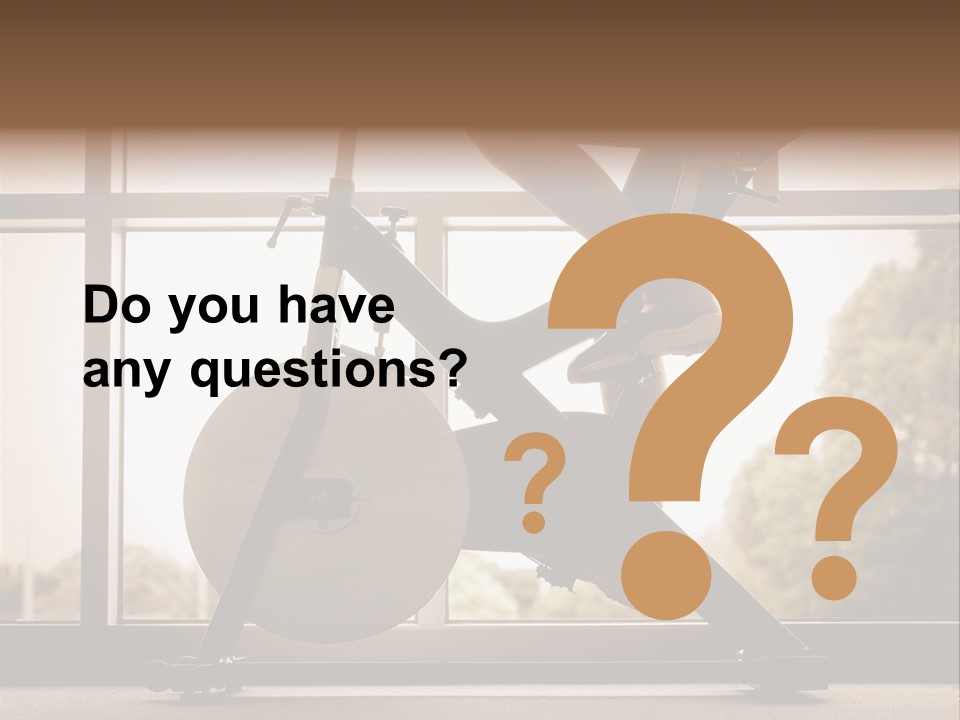 A Woman Riding A Stationary Bike In A Gym PowerPoint Template