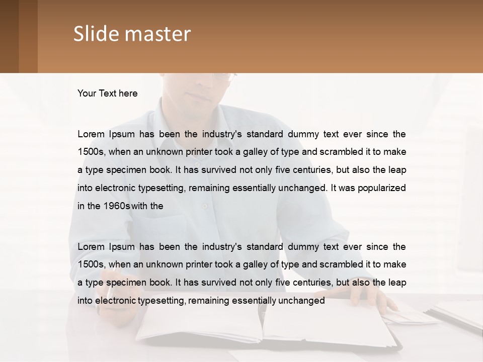 A Man Sitting At A Desk In Front Of A Computer PowerPoint Template