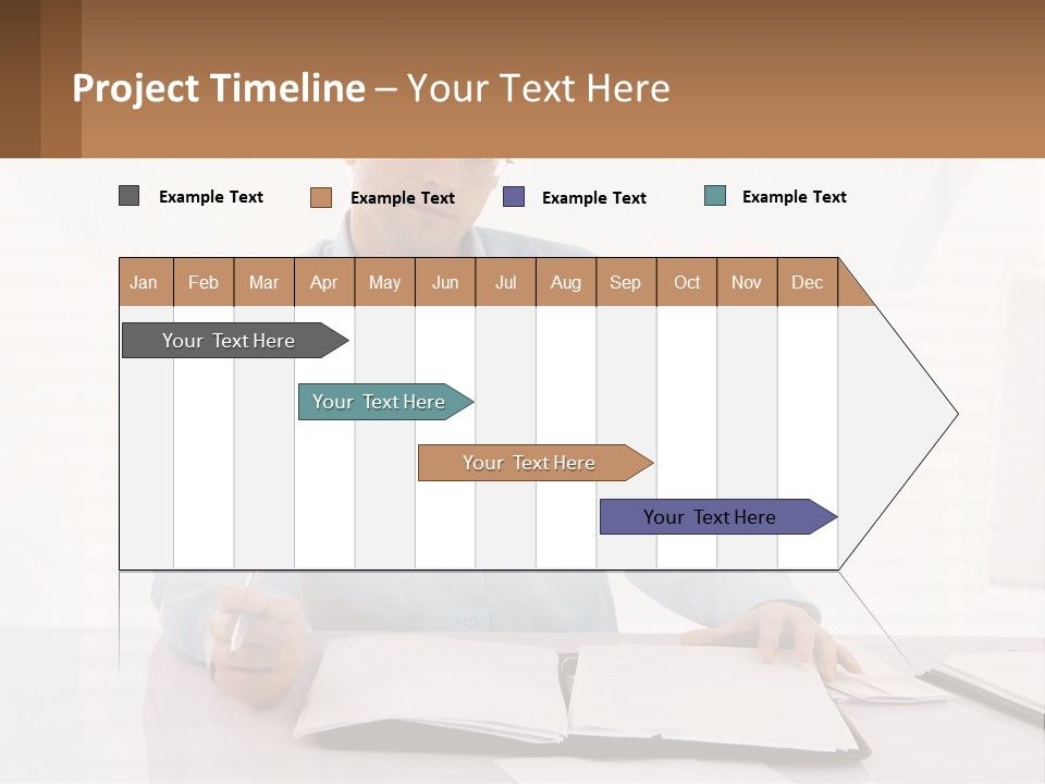 A Man Sitting At A Desk In Front Of A Computer PowerPoint Template