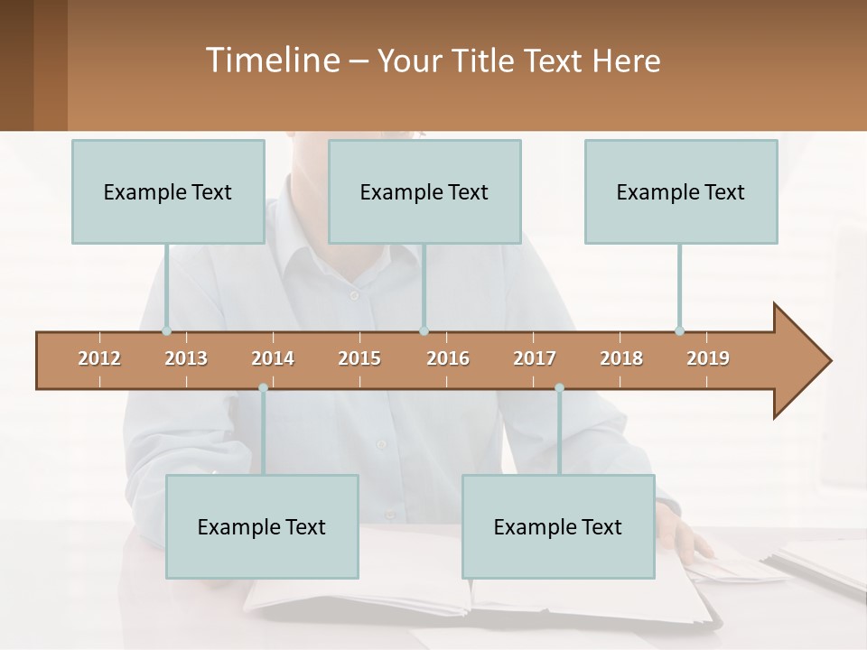 A Man Sitting At A Desk In Front Of A Computer PowerPoint Template