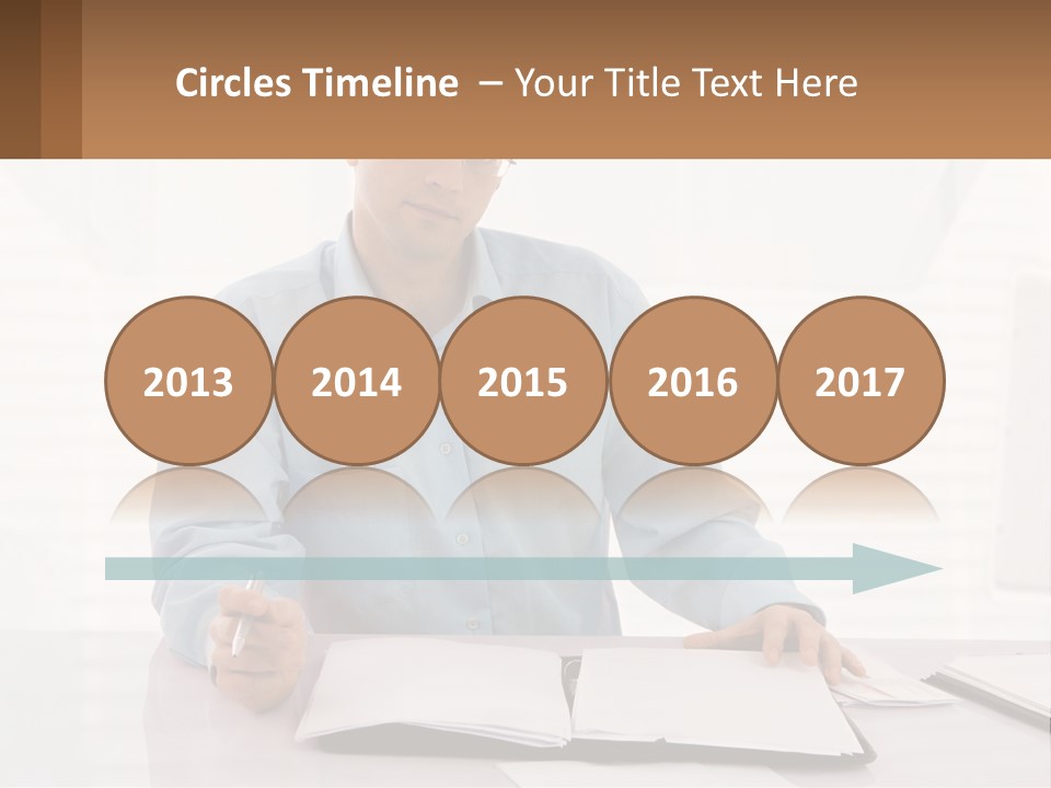 A Man Sitting At A Desk In Front Of A Computer PowerPoint Template