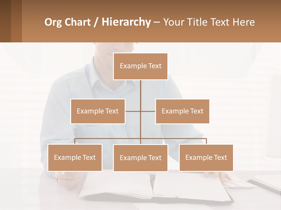 A Man Sitting At A Desk In Front Of A Computer PowerPoint Template