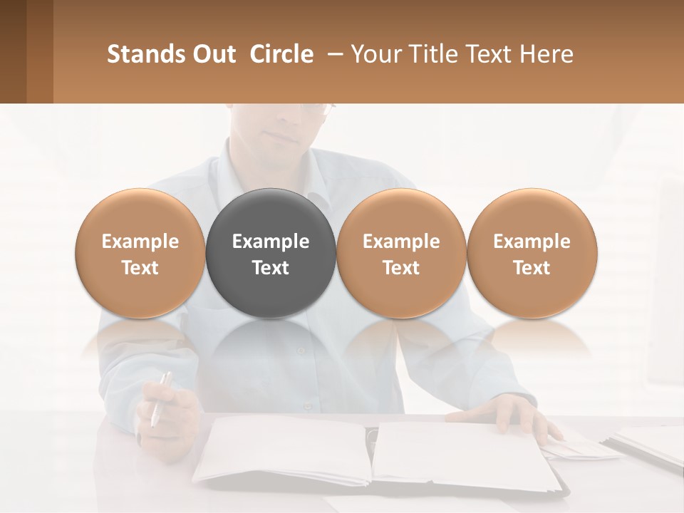 A Man Sitting At A Desk In Front Of A Computer PowerPoint Template