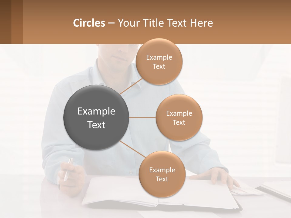 A Man Sitting At A Desk In Front Of A Computer PowerPoint Template