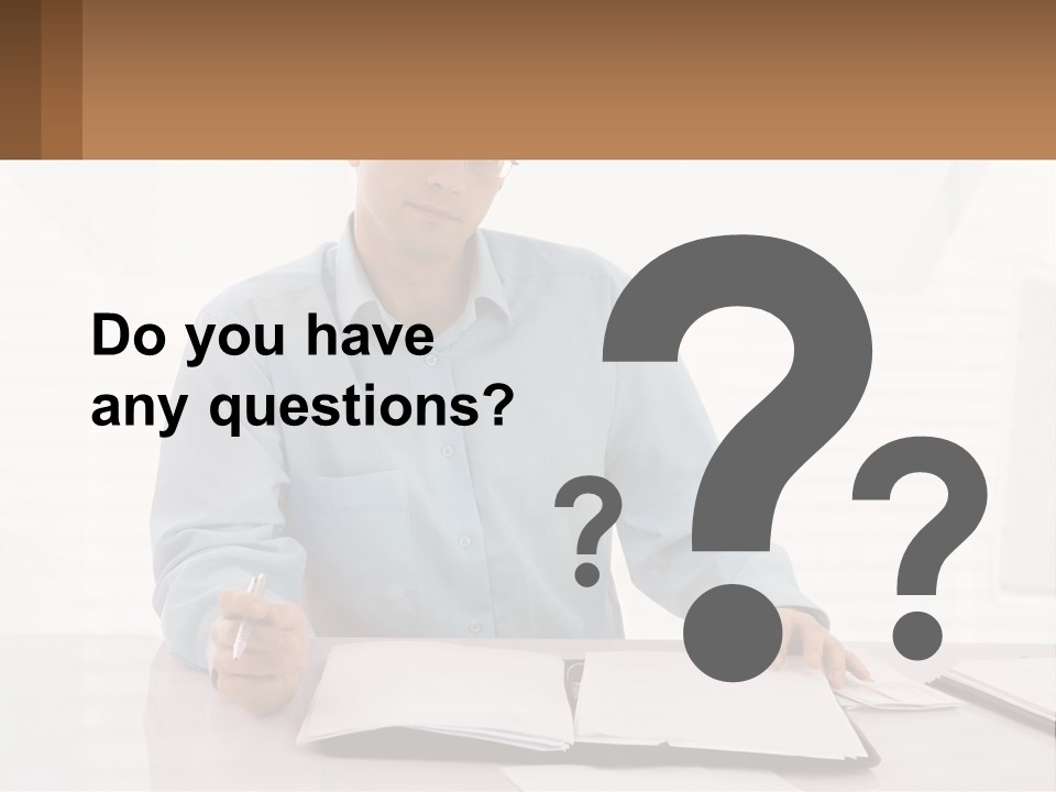 A Man Sitting At A Desk In Front Of A Computer PowerPoint Template