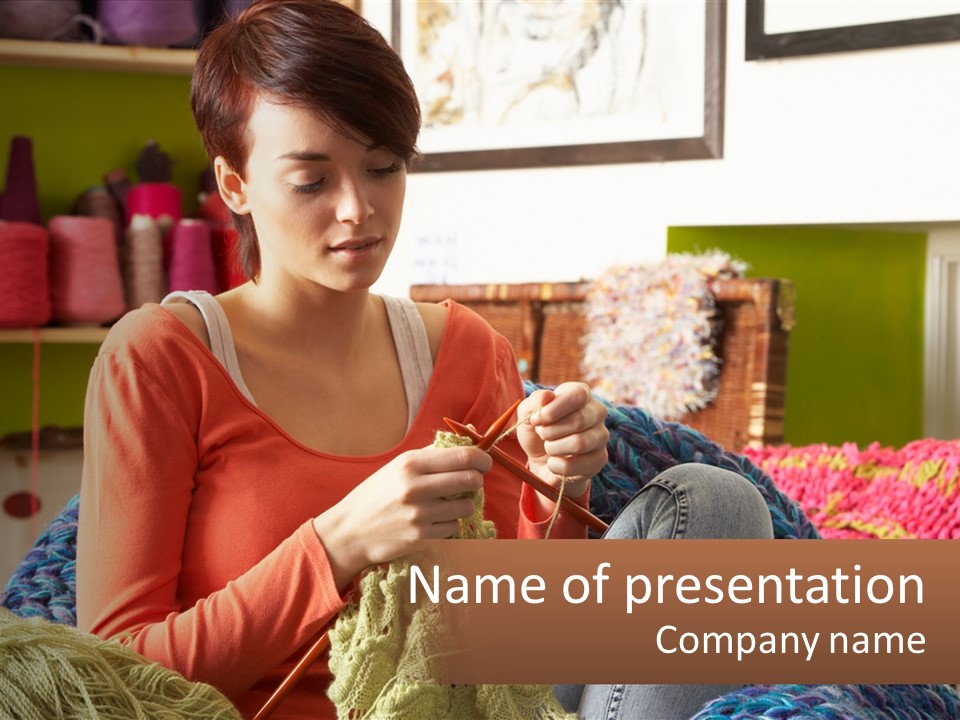 A Woman Sitting On A Couch Knitting A Piece Of Yarn PowerPoint Template