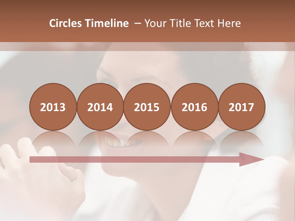 A Woman Sitting At A Table With A Smile On Her Face PowerPoint Template