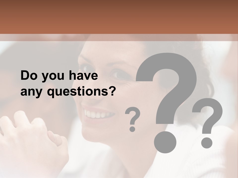 A Woman Sitting At A Table With A Smile On Her Face PowerPoint Template