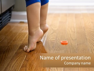 A Person Standing On A Wooden Floor Next To An Orange Object PowerPoint Template