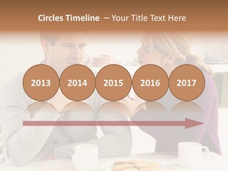 A Man And Woman Sitting At A Table Talking PowerPoint Template