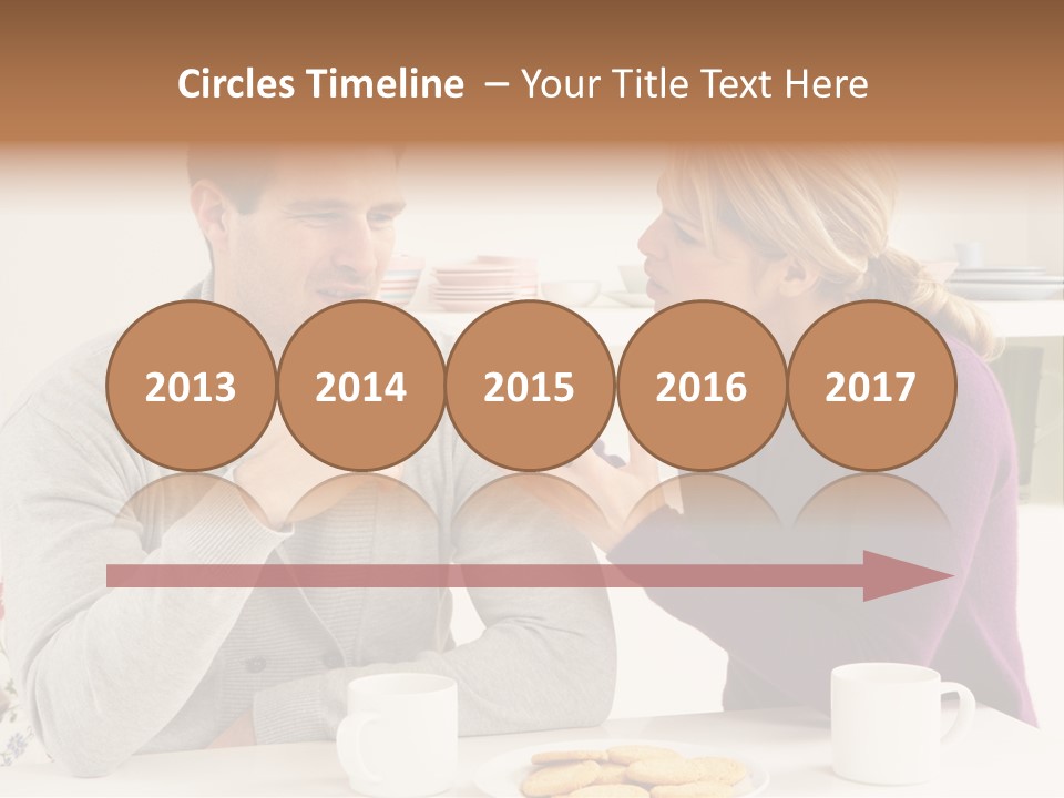 A Man And Woman Sitting At A Table Talking PowerPoint Template