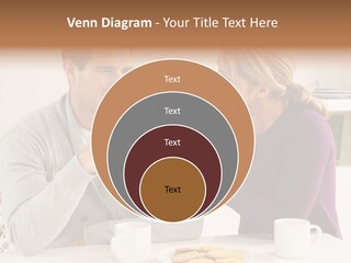 A Man And Woman Sitting At A Table Talking PowerPoint Template