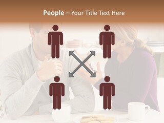 A Man And Woman Sitting At A Table Talking PowerPoint Template
