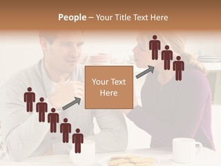 A Man And Woman Sitting At A Table Talking PowerPoint Template