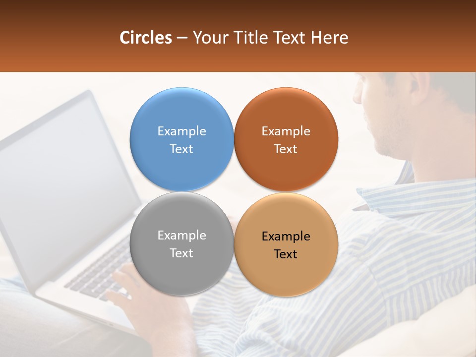 A Man Sitting On A Couch Using A Laptop Computer PowerPoint Template