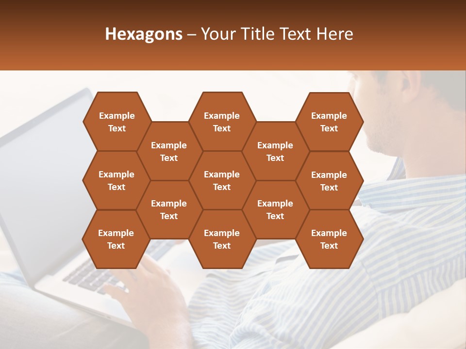 A Man Sitting On A Couch Using A Laptop Computer PowerPoint Template