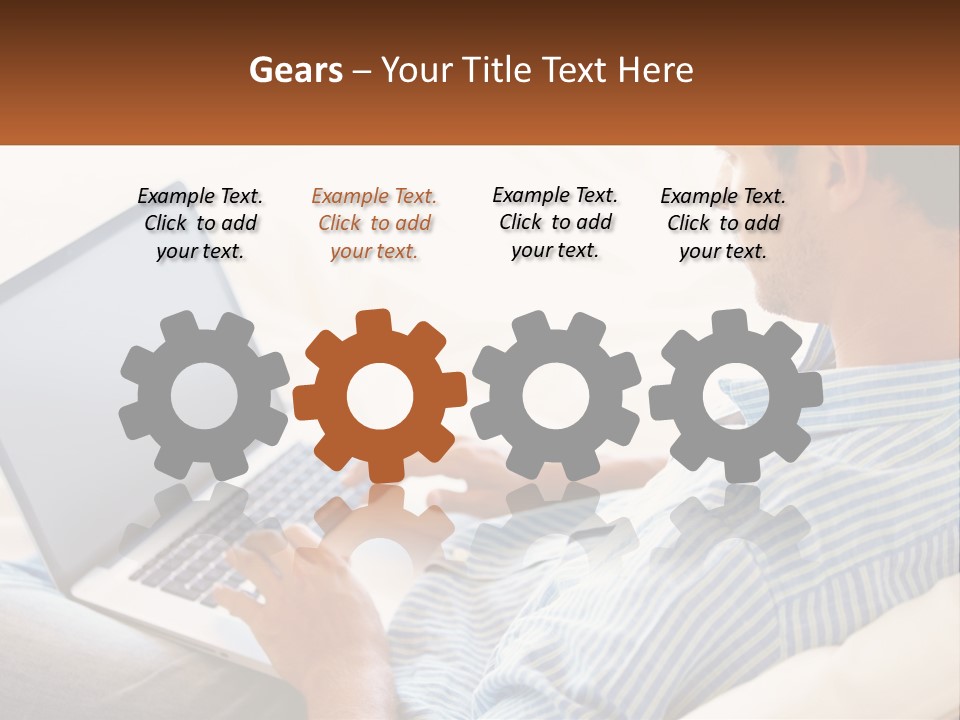 A Man Sitting On A Couch Using A Laptop Computer PowerPoint Template