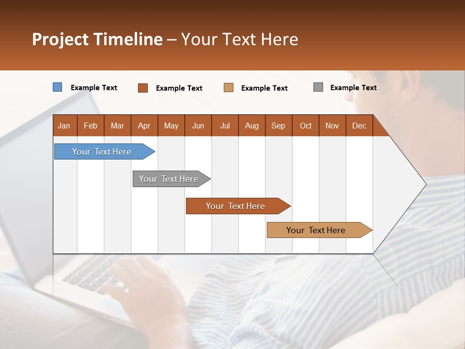 A Man Sitting On A Couch Using A Laptop Computer PowerPoint Template