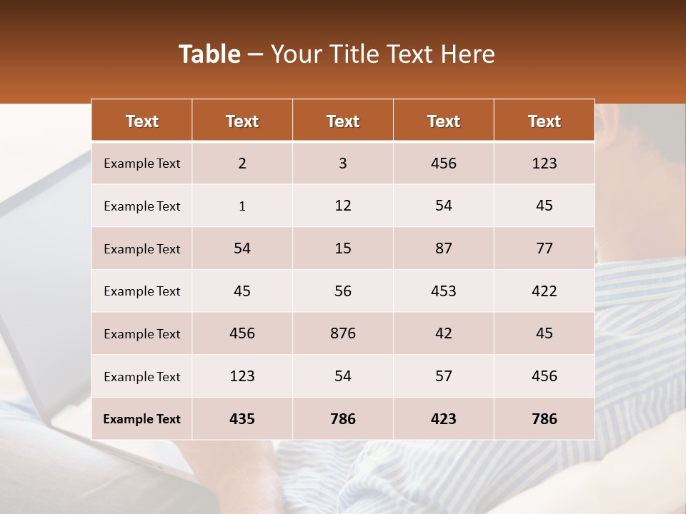 A Man Sitting On A Couch Using A Laptop Computer PowerPoint Template