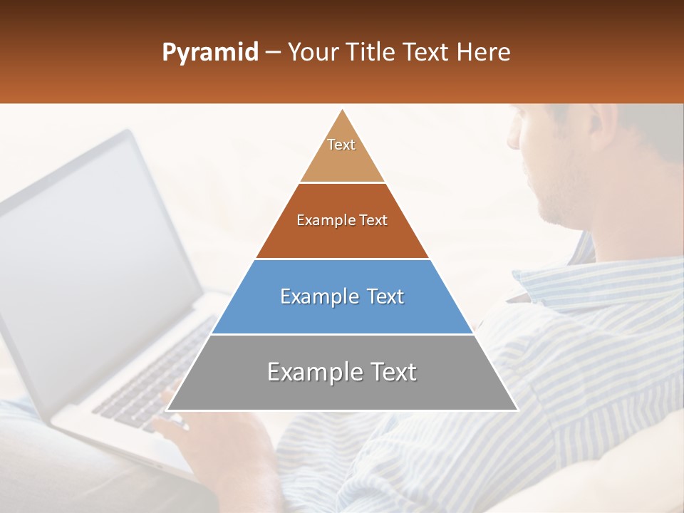 A Man Sitting On A Couch Using A Laptop Computer PowerPoint Template