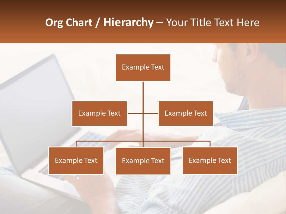 A Man Sitting On A Couch Using A Laptop Computer PowerPoint Template