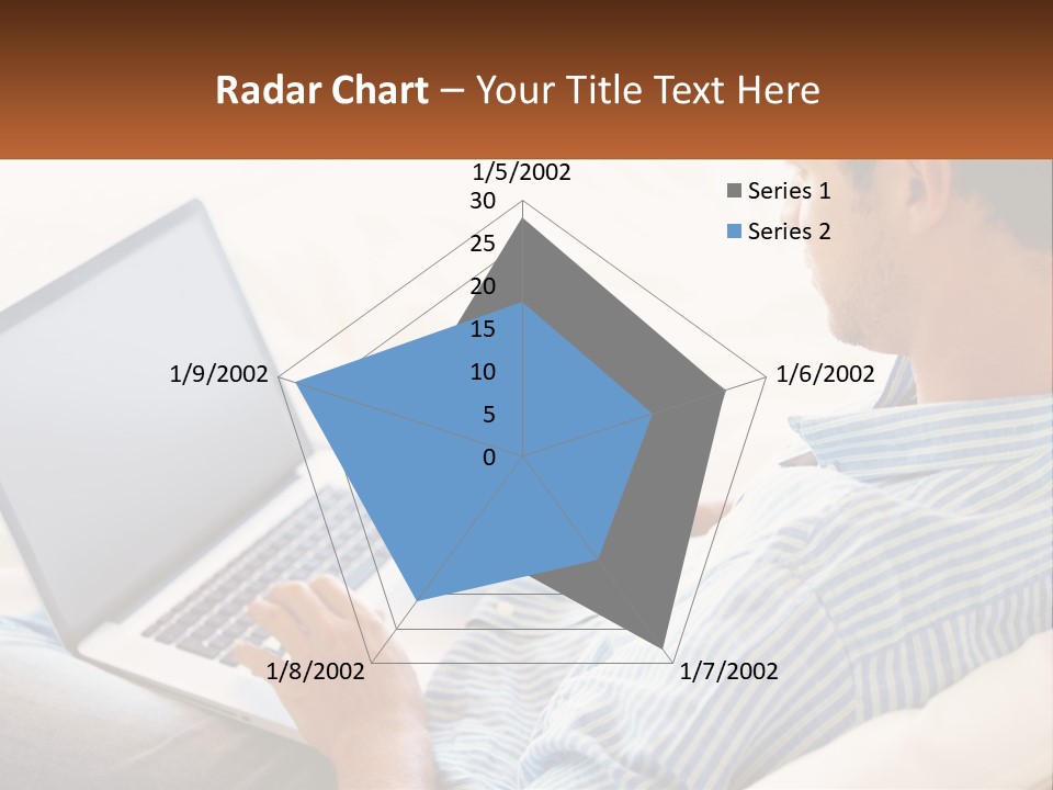 A Man Sitting On A Couch Using A Laptop Computer PowerPoint Template