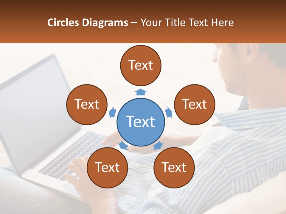 A Man Sitting On A Couch Using A Laptop Computer PowerPoint Template