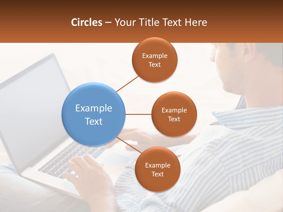 A Man Sitting On A Couch Using A Laptop Computer PowerPoint Template