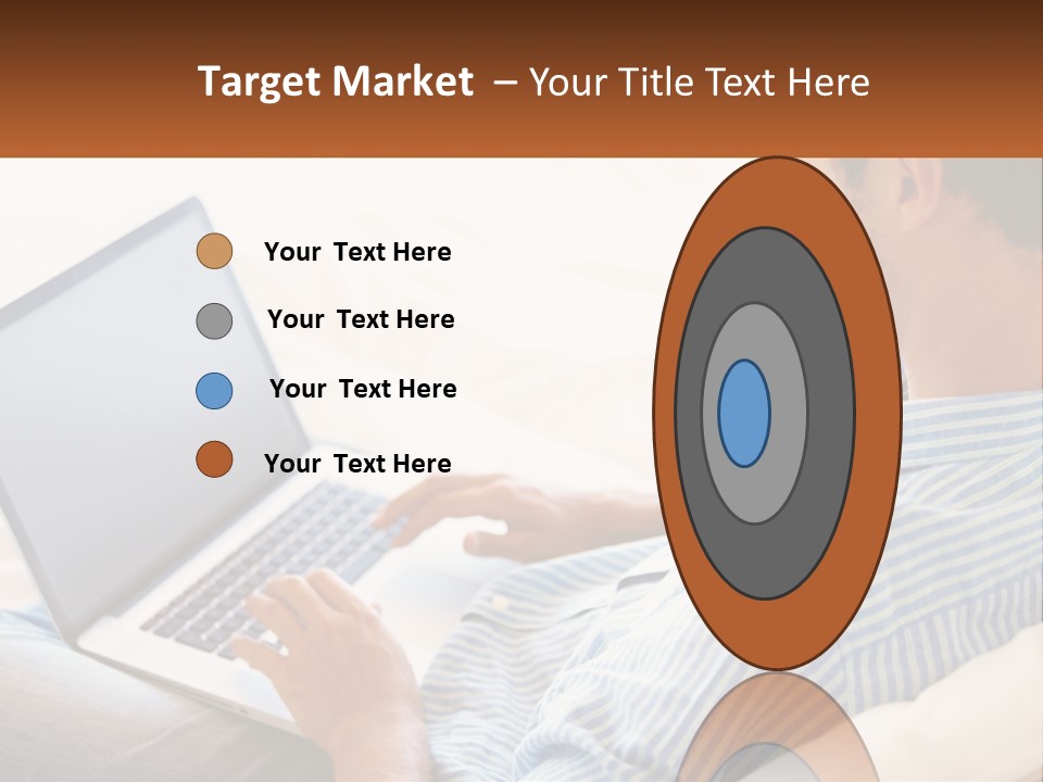 A Man Sitting On A Couch Using A Laptop Computer PowerPoint Template