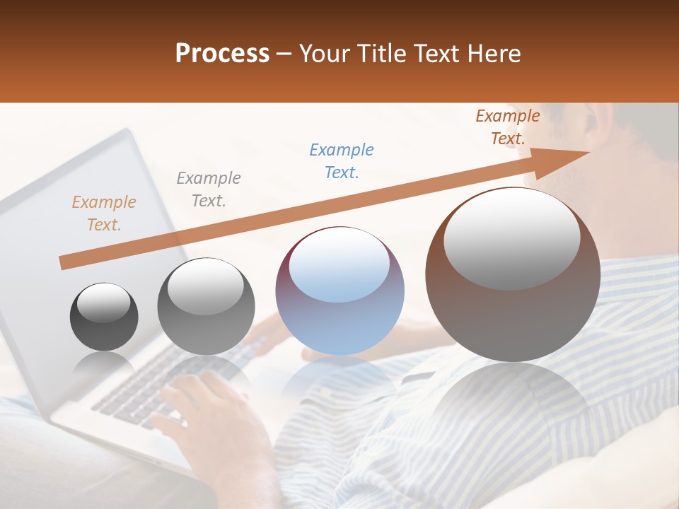 A Man Sitting On A Couch Using A Laptop Computer PowerPoint Template
