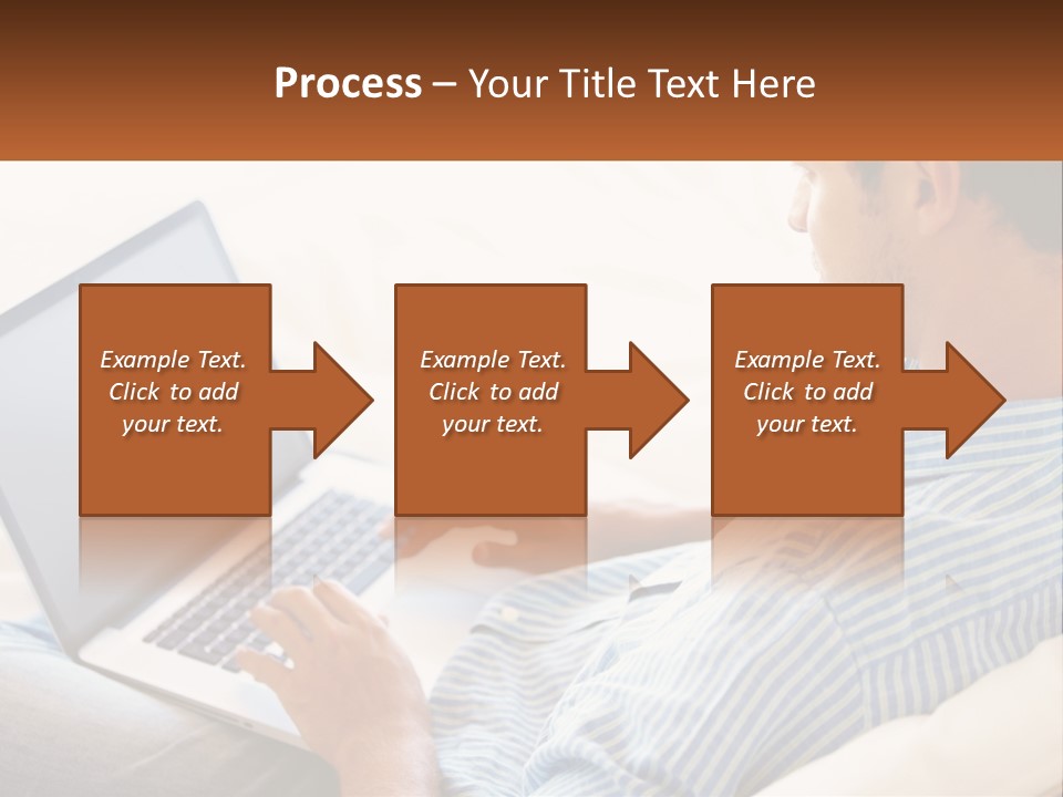 A Man Sitting On A Couch Using A Laptop Computer PowerPoint Template