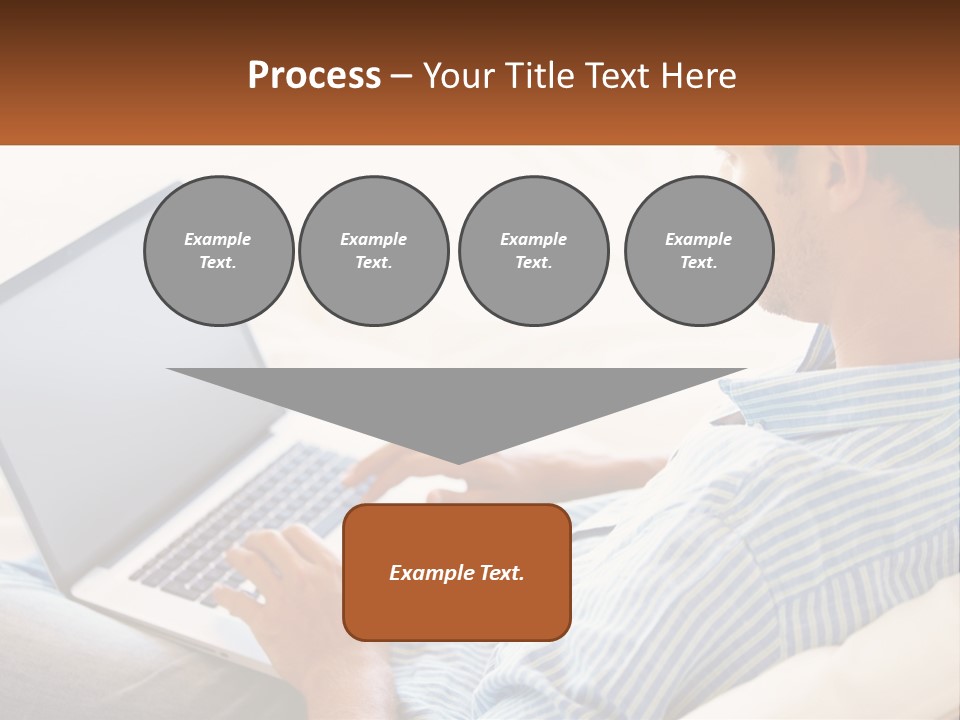 A Man Sitting On A Couch Using A Laptop Computer PowerPoint Template