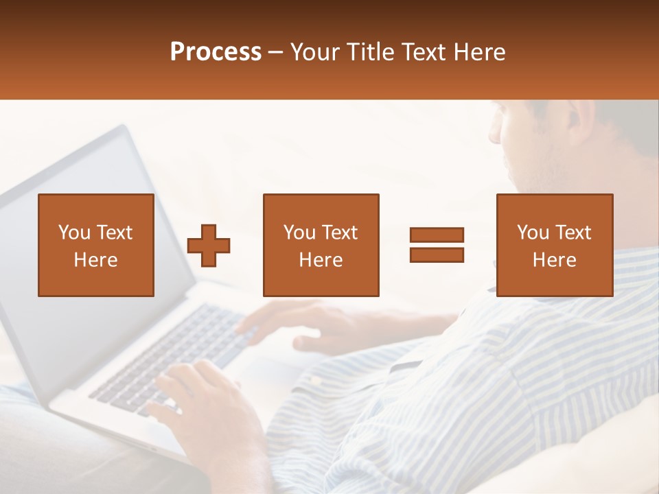 A Man Sitting On A Couch Using A Laptop Computer PowerPoint Template