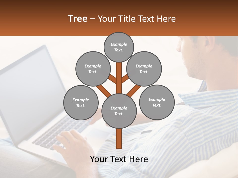 A Man Sitting On A Couch Using A Laptop Computer PowerPoint Template