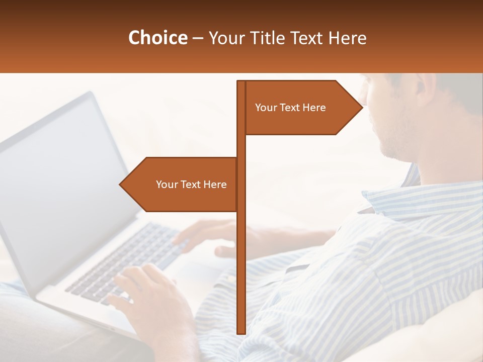 A Man Sitting On A Couch Using A Laptop Computer PowerPoint Template