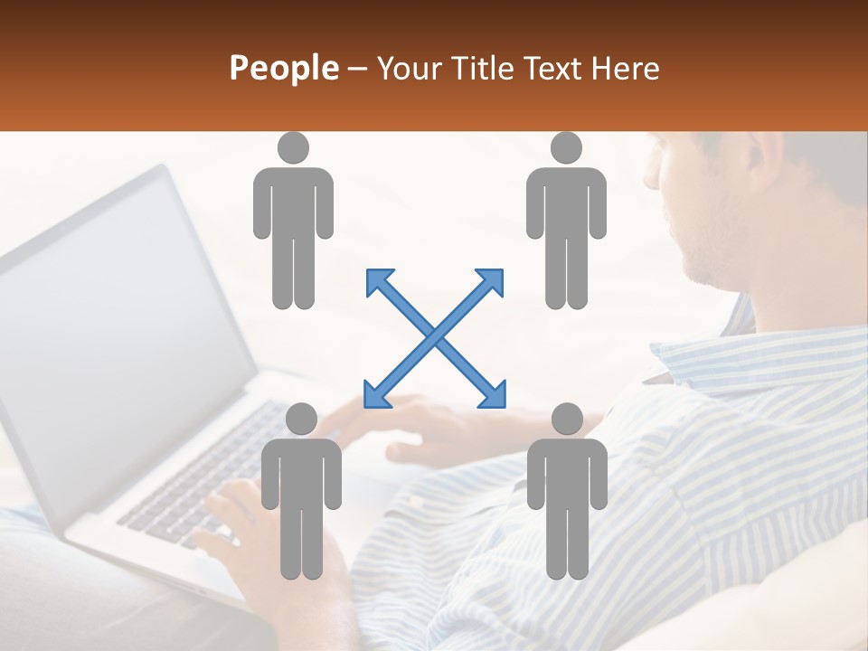 A Man Sitting On A Couch Using A Laptop Computer PowerPoint Template