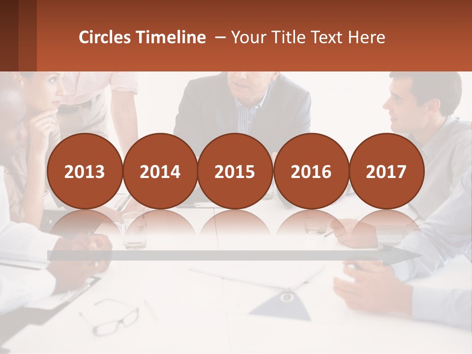 A Group Of People Sitting Around A Table Talking PowerPoint Template